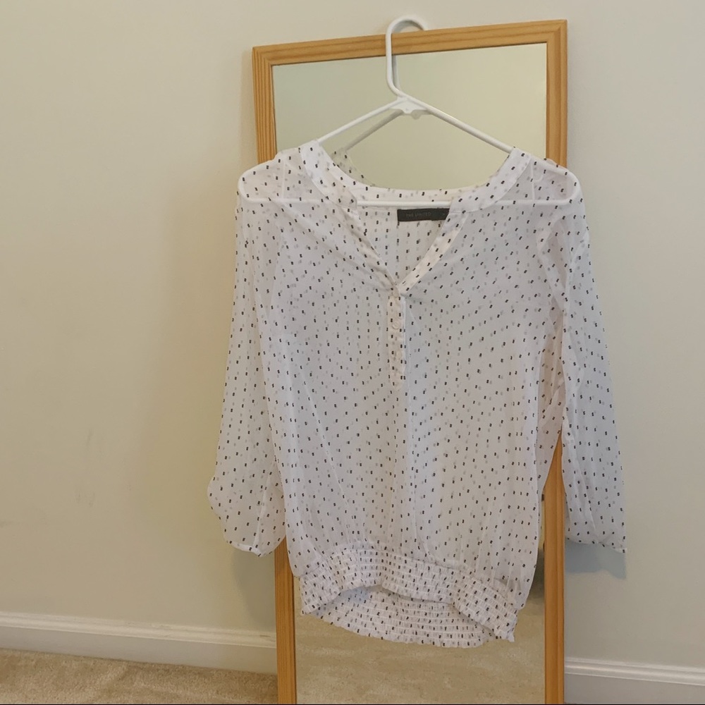 White and black polka dotted blouse